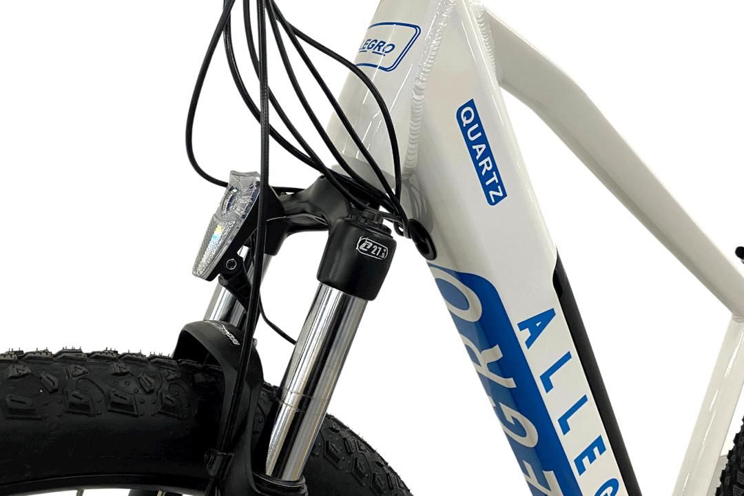 Detail of Eff Bike Allegro Quartz Electric Bike's front light and suspension